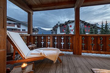A wooden deck with a chair and a candle on it