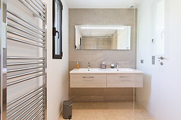 A bathroom with two sinks and a mirror