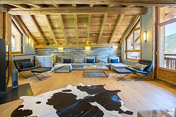 A living room with a cowhide rug on the floor