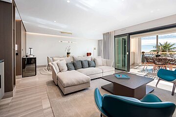 A living room with a couch and chairs and a table