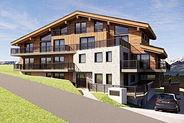 Modern multi-story chalet with wood and stone facades on a grassy hillside, featuring balconies and a parked car.