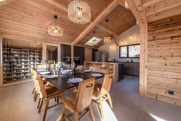 A kitchen with a table and chairs in it