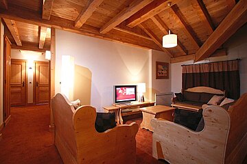 A living room with wooden furniture and a flat screen tv