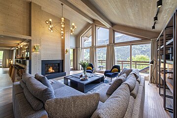 A living room with a fireplace and lots of windows