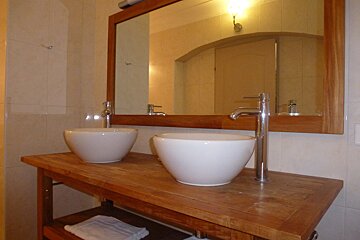 A bathroom with two sinks and a mirror