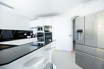 A kitchen with a stainless steel electrolux refrigerator