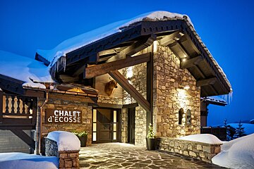 The chalet d' ecosse is lit up at night