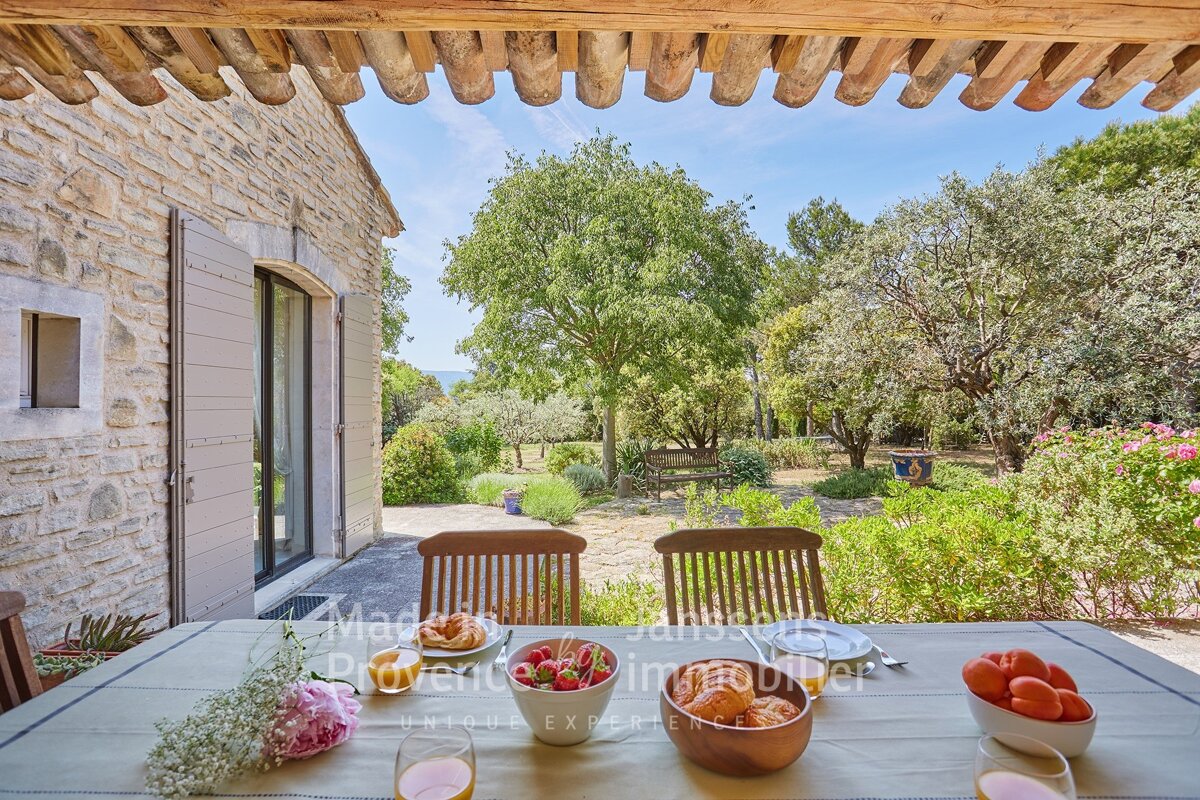 A table with a bowl of fruit on it that says provence immobilier