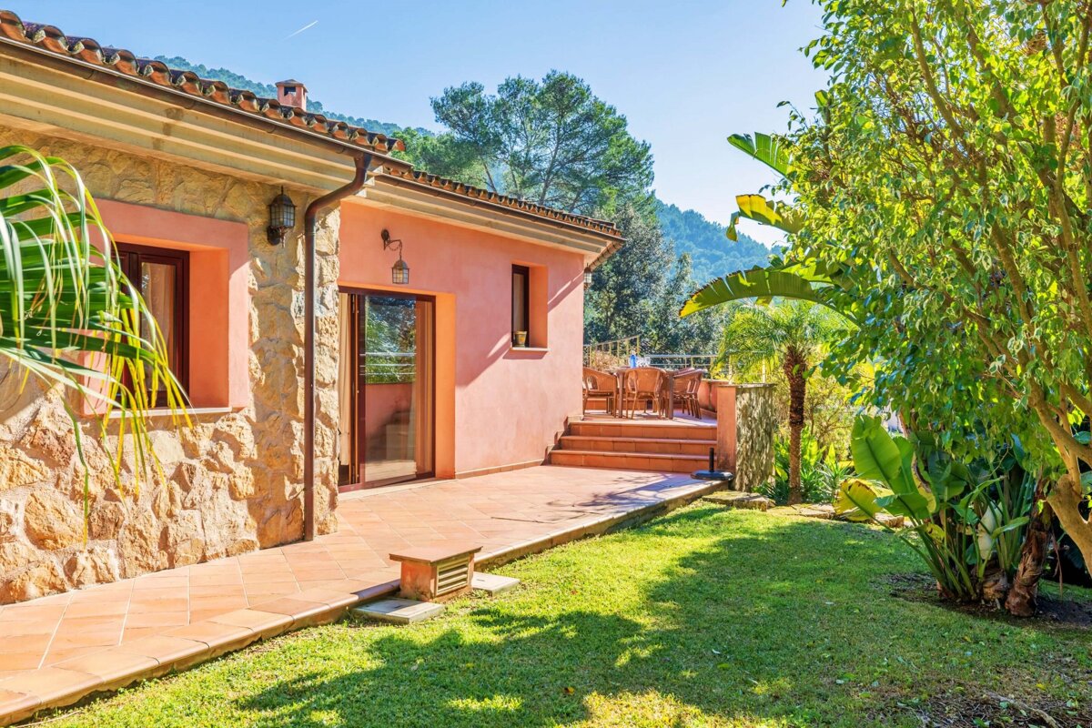 A pink house with a patio in front of it