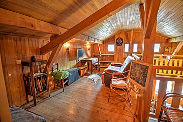A wooden room with a dart board on the wall