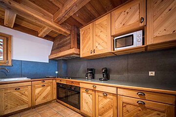 A kitchen with wooden cabinets and a lg microwave