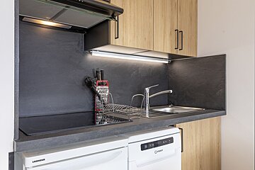 A kitchen with a liebherr dishwasher and an indesit dishwasher