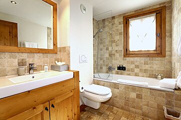 A bathroom with a toilet a sink and a bathtub