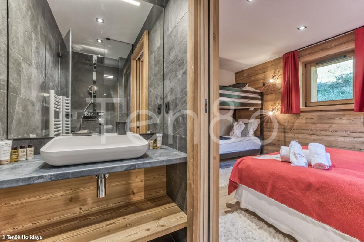 A bathroom with a sink and a bunk bed