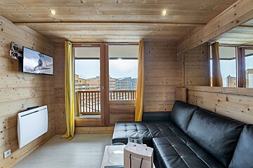 A living room with a couch and a flat screen tv