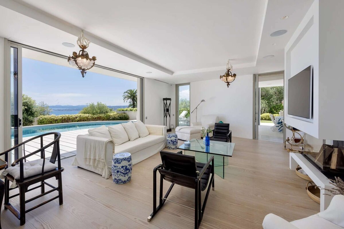 A living room with a couch and chairs and a television