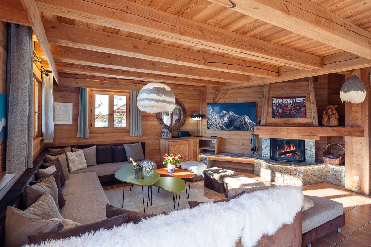 A living room with a large sectional couch and a fireplace