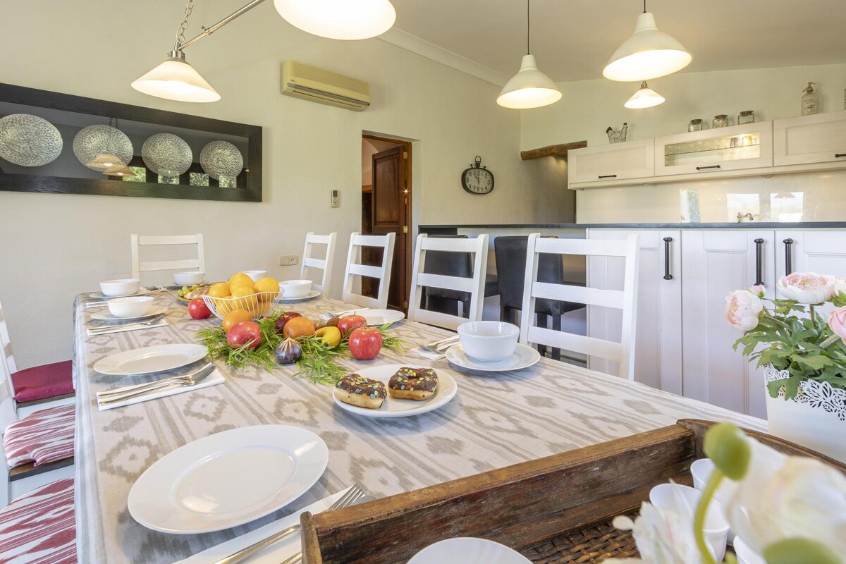 A dining room table with plates and fruit on it