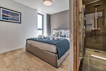 A bedroom with a bed and a picture on the wall