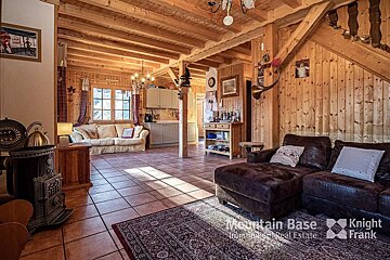 A living room with a couch and a rug that says mountain base knight frank