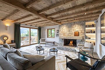 A living room with a stone fireplace and a couch