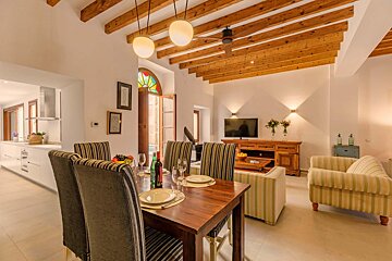 A living room with a dining table and chairs