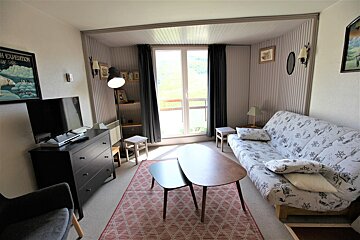 A living room with a couch and a tv and a poster on the wall that says high expedition