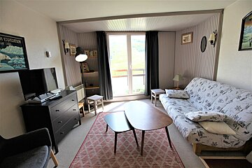 A living room with a couch and a tv and a poster on the wall that says high expedition