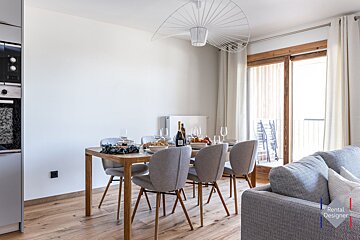 A dining room table with a bottle of champagne on it