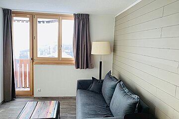 A living room with a couch and a lamp