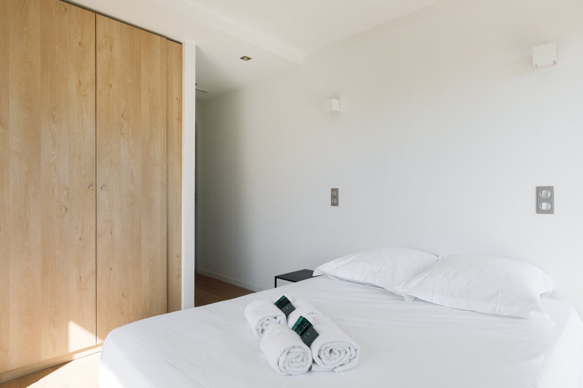 A bedroom with a bed and two towels on it