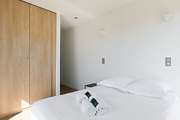 A bedroom with a bed and two towels on it