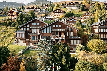 A group of houses on a hillside with the letter vip on the bottom