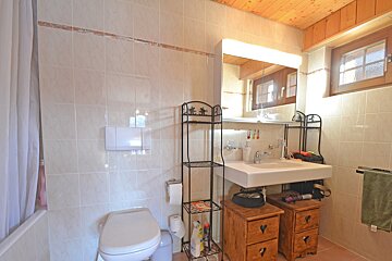 A bathroom with a toilet a sink and a mirror