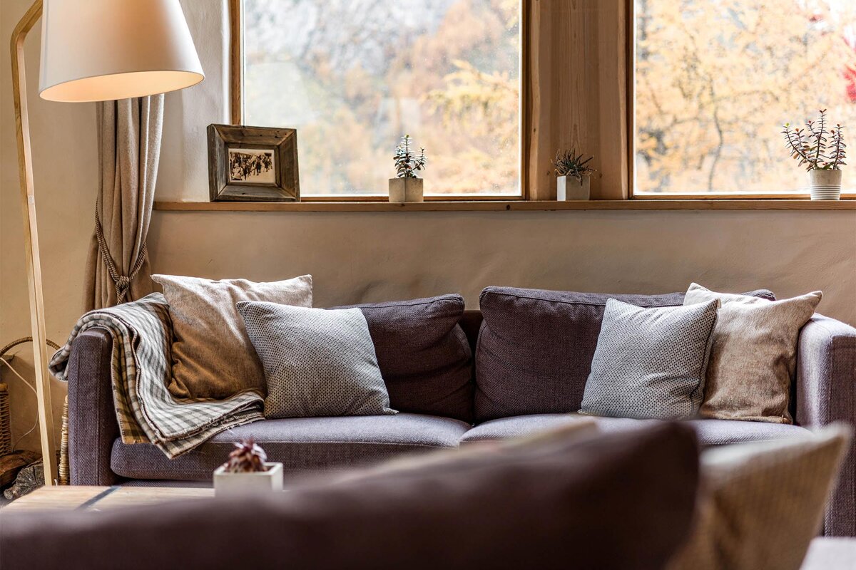 A living room with a couch and a lamp