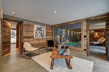 A room with a painting of a wolf on the wall