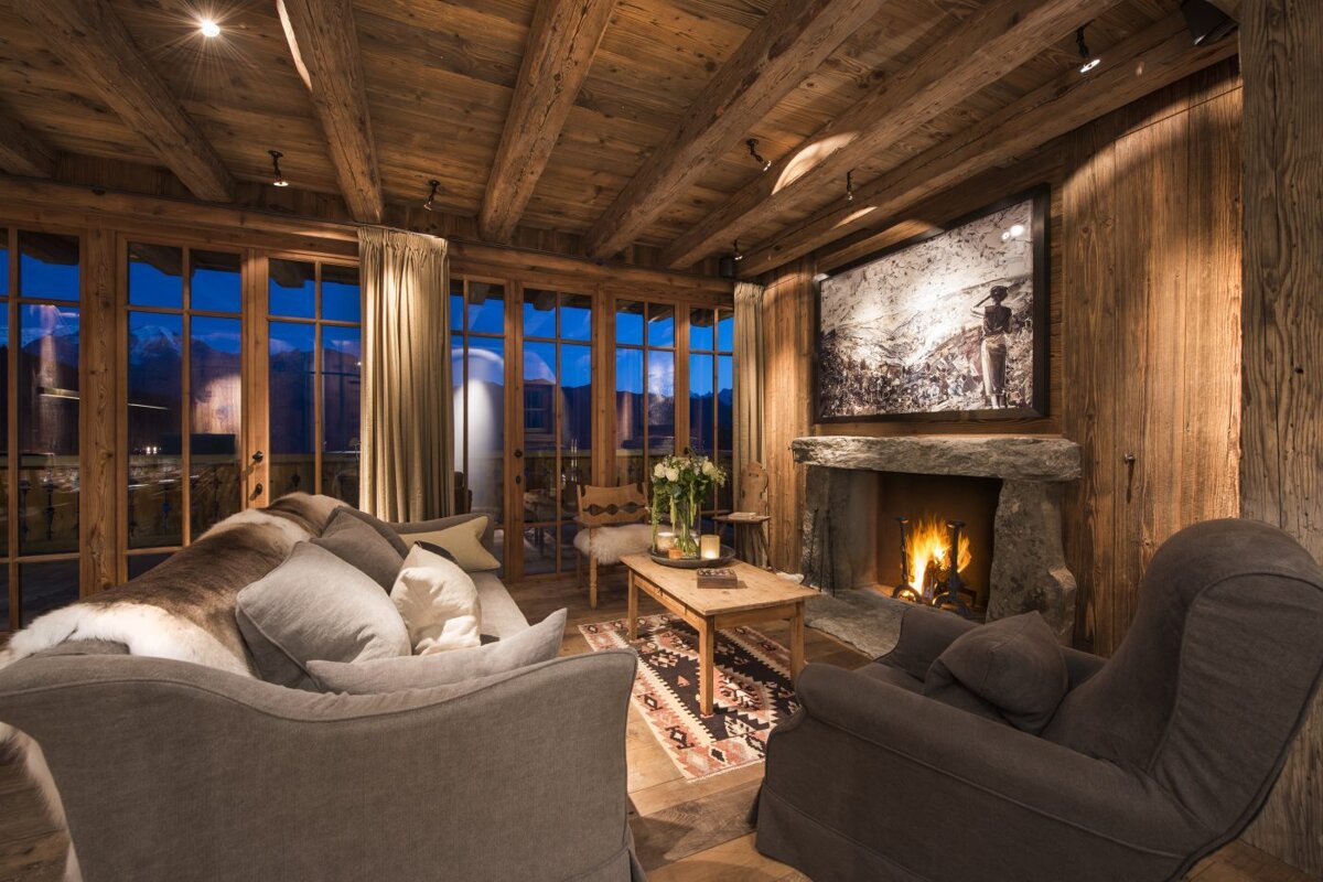 A living room with a fireplace and a picture on the wall
