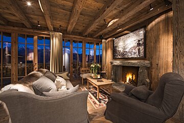 A living room with a fireplace and a picture on the wall