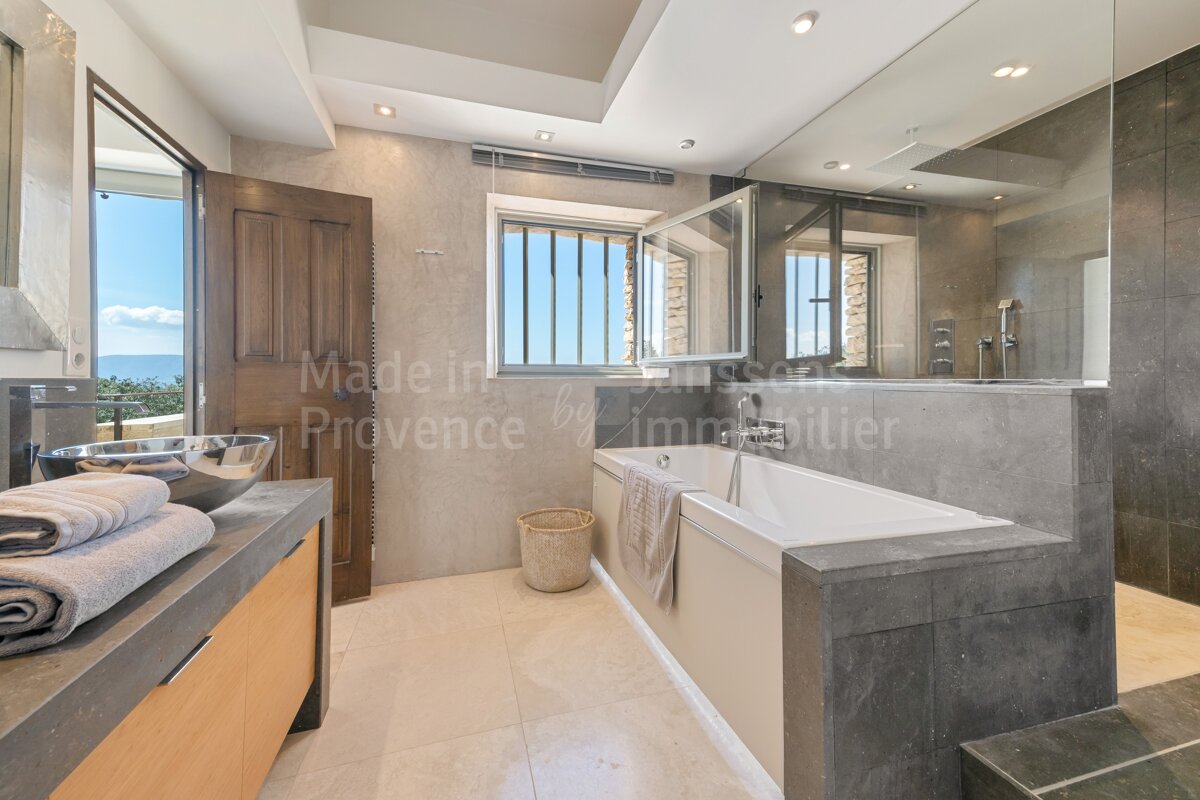 A bathroom with a bathtub and a sink made in provence by immobilier