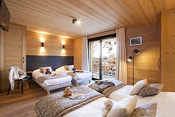 A bedroom with two beds and a picture on the wall