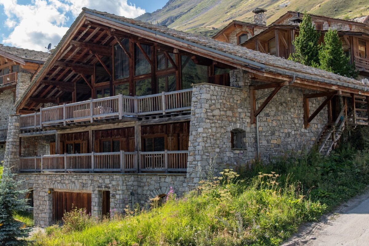 A large stone building with a wooden roof and balconies