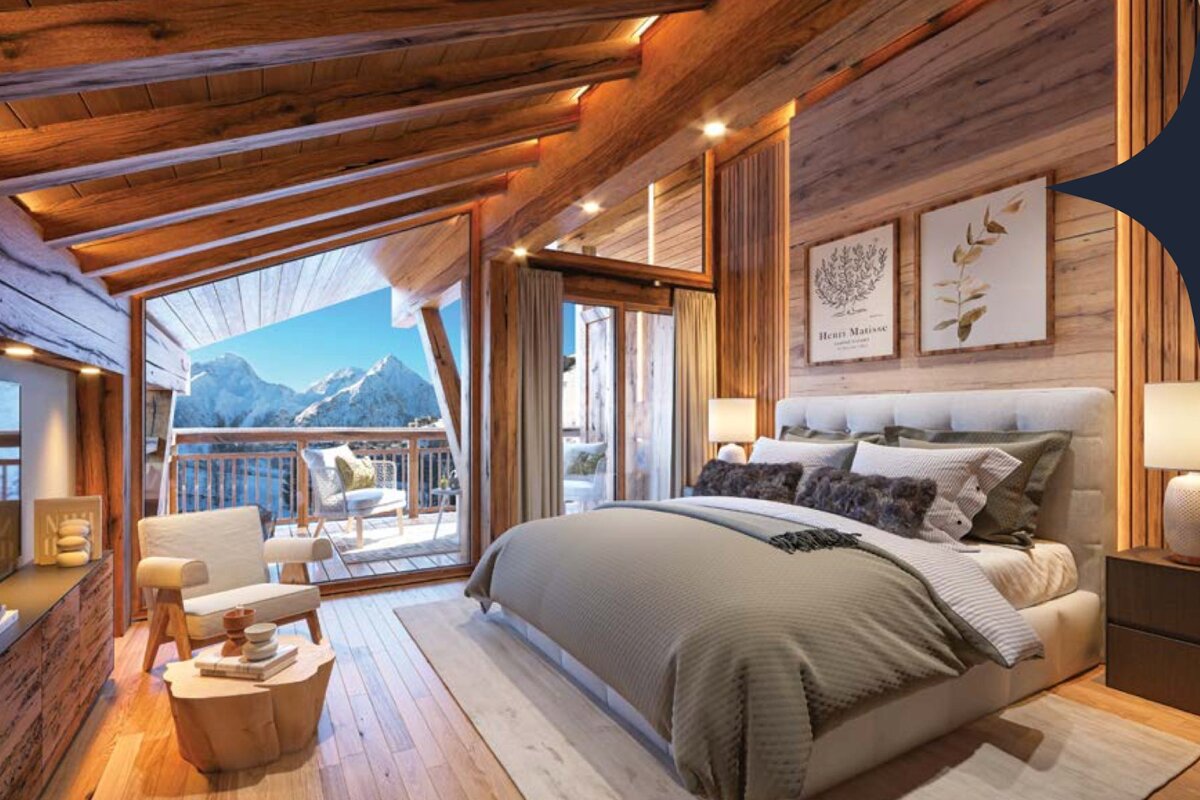 Cozy alpine chalet bedroom with warm wood ceilings, a large plush bed, and sliding doors opening to a scenic mountain balcony.