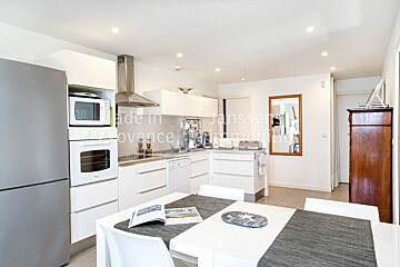 A kitchen with white cabinets and a refrigerator that says made in provence