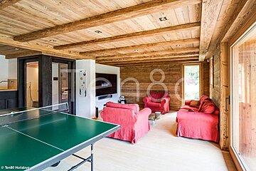 A ping pong table sits in the middle of a living room