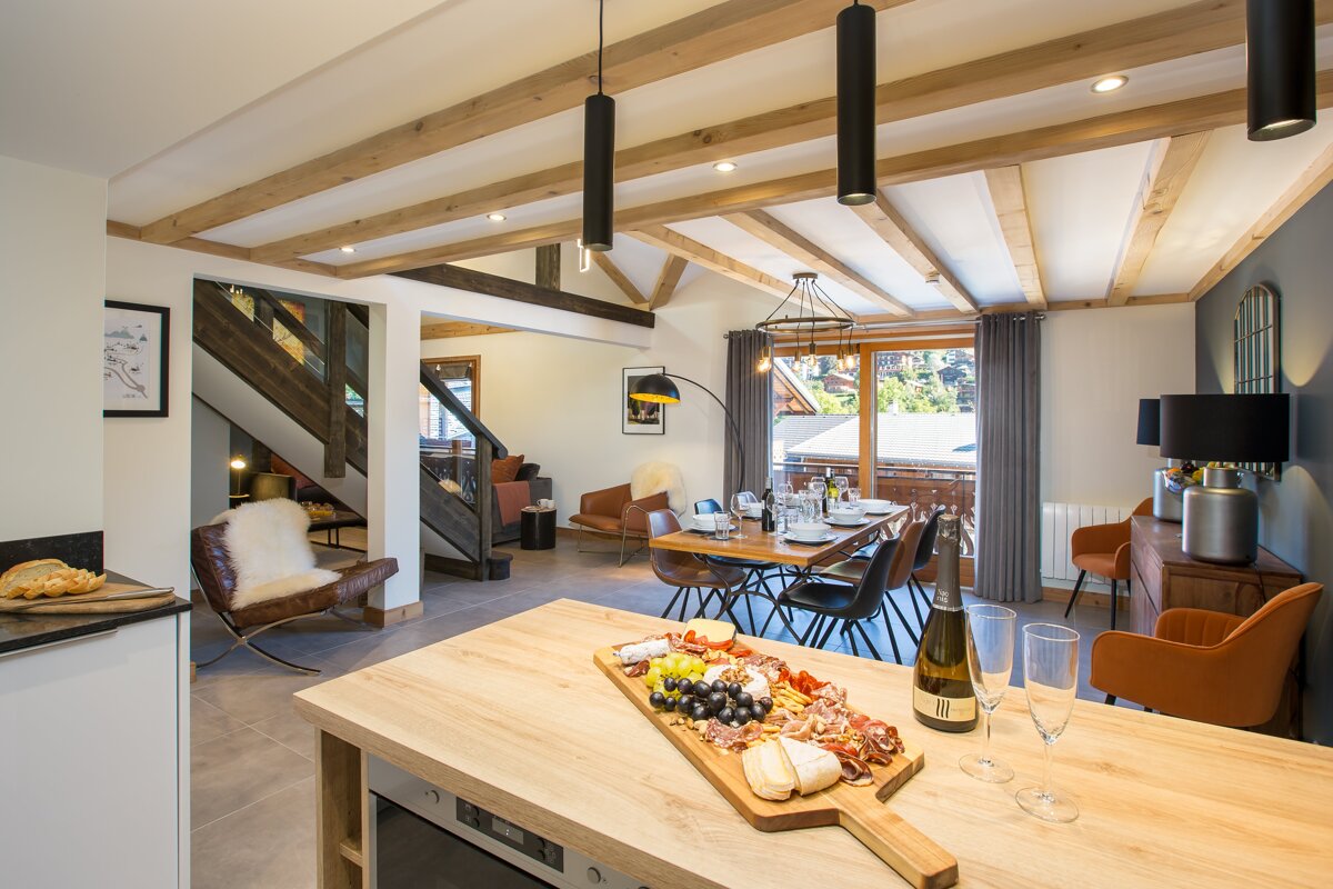 A bottle of champagne sits on a counter in a living room
