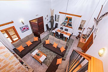 An aerial view of a living room and dining room