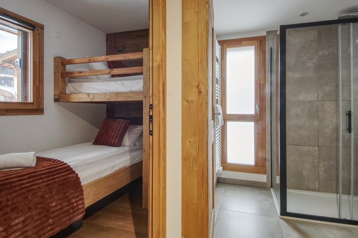 A bedroom with bunk beds and a walk in shower