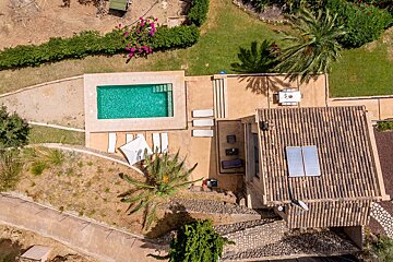 An aerial view of a house with a swimming pool