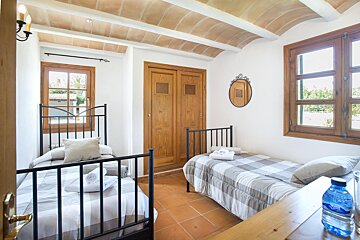 A bedroom with two beds and a bottle of aquafina water
