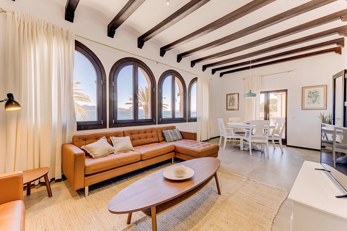 A living room with arched windows and a brown couch